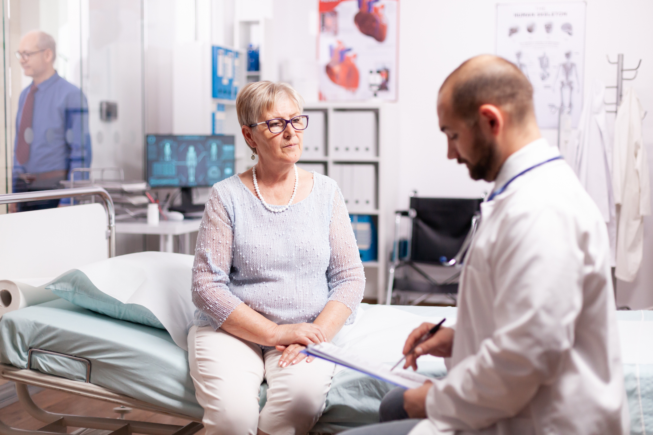 Senior Woman Listening Doctor Talking About Treatment